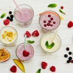 smoothie recipes - an array of drinks surrounded by fruit