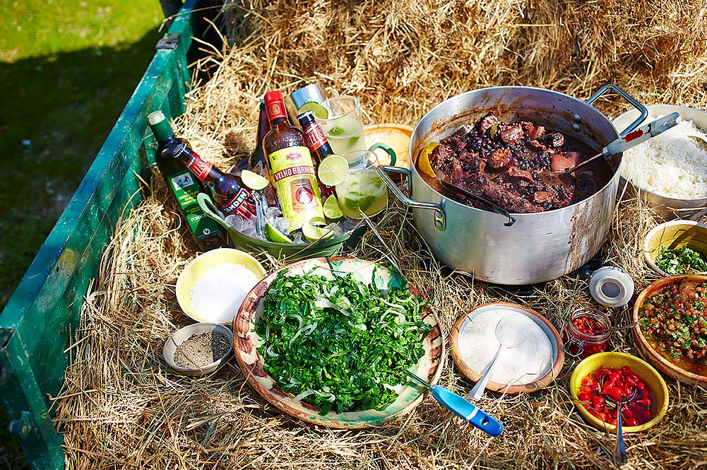 Feijoada - stew with salad and alcohol in hay