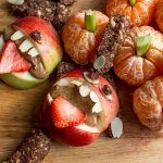 Healthy Halloween treats with apples and strawberries looking like monsters