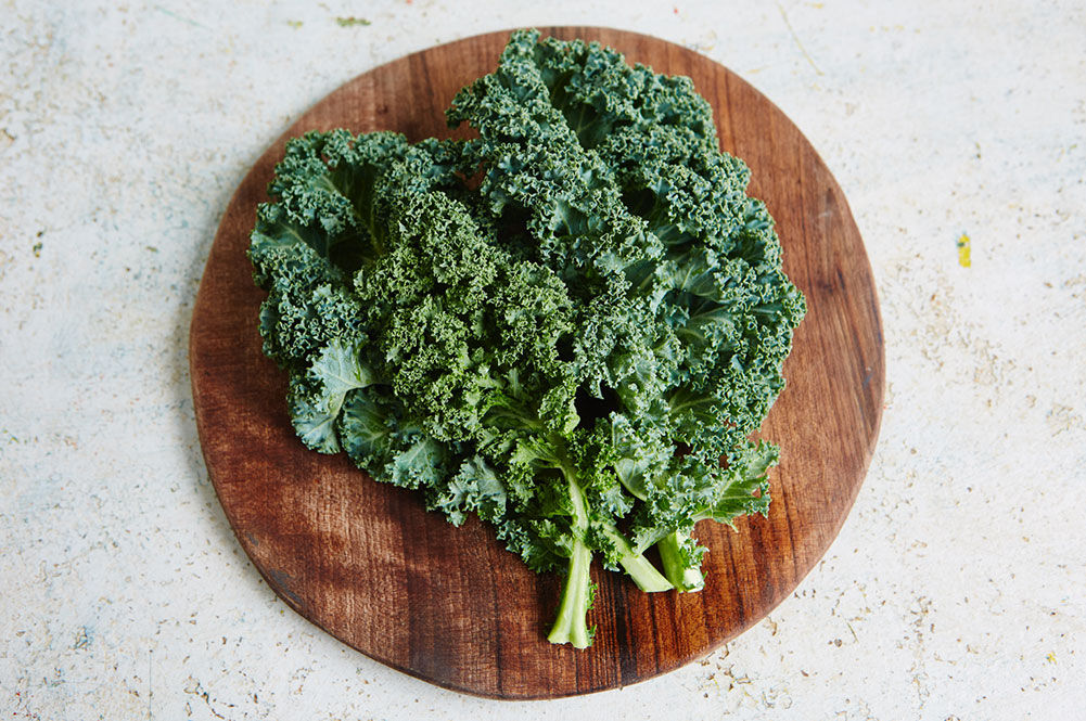 bunch of kale on a chopping board