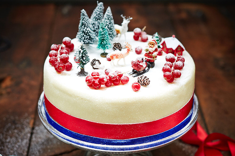 christmas cake with icing dusting and christmas decorations