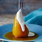 poached pears in sauce with cream on top