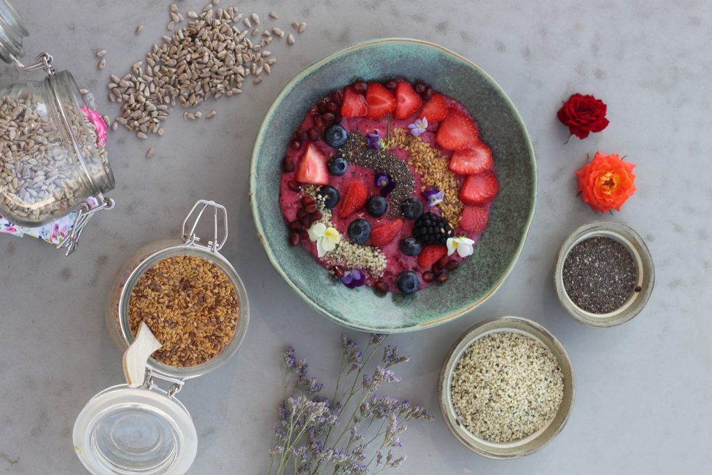 omega feature - bowl of fruit with grains, seeds and oats