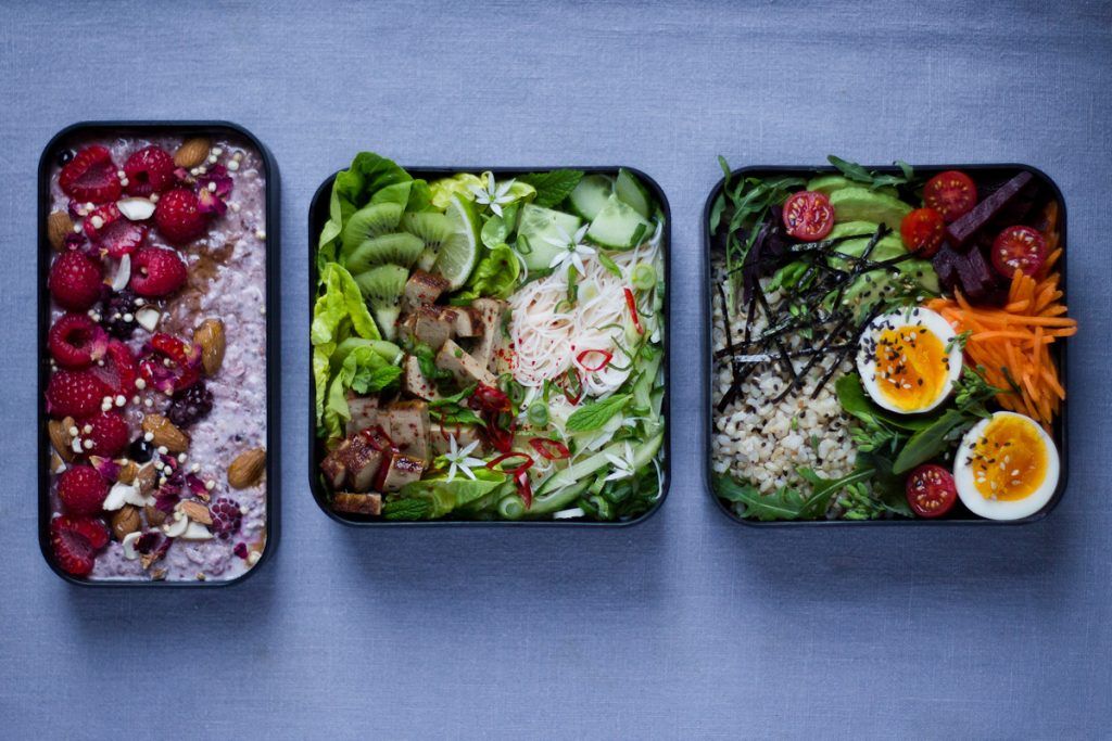 bento boxes with Asian inspired recipes. Fruit fishes and vegetable salad dishes.