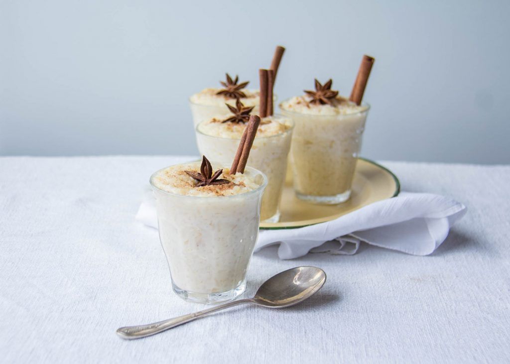Brazilian rice pudding in cups with star anise and cinnamon sticks