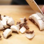 mushrooms being sliced on a chopping board - mushroom recipes