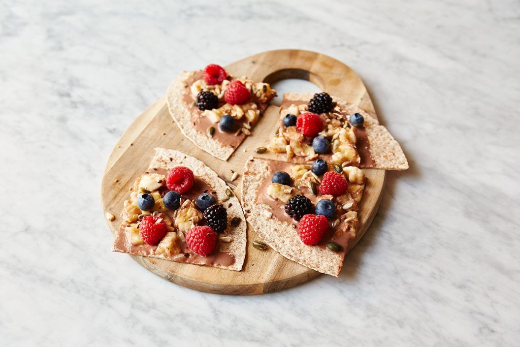 breakfast fruit recipe with fruit and nuts on top of wraps