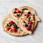 breakfast fruit recipe with fruit and nuts on top of wraps