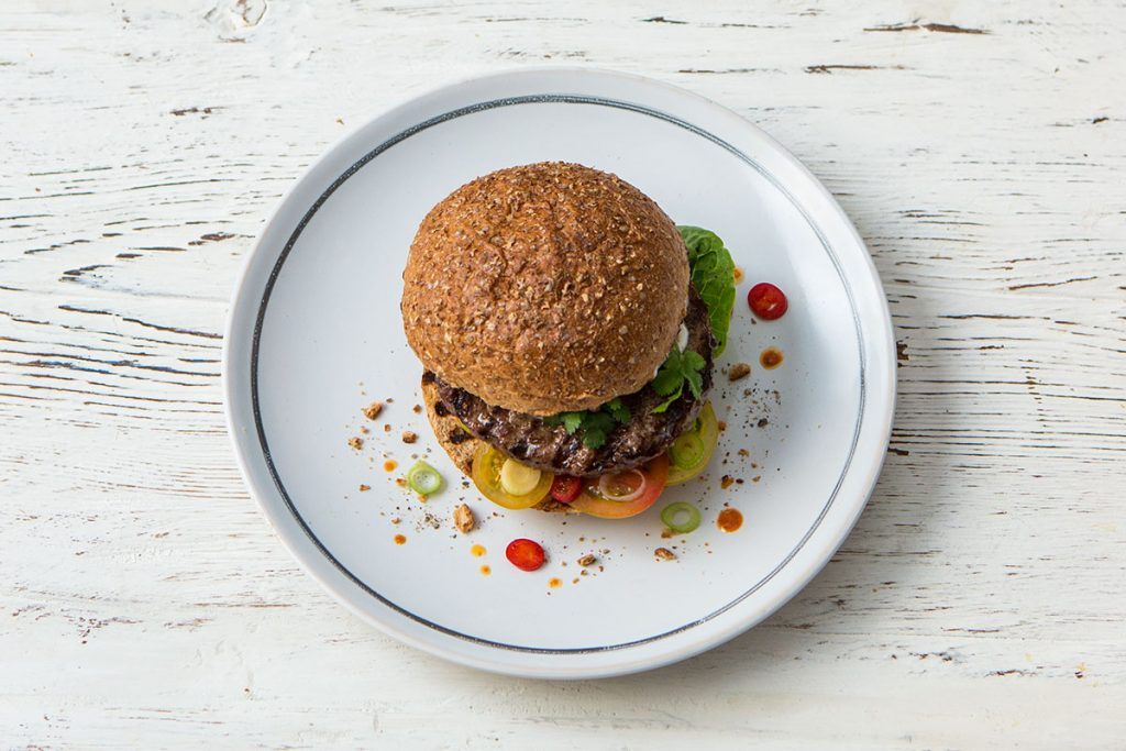 mexican style beef burger with chilli and tomatoes