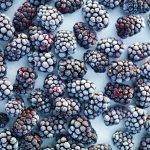 frozen blackberries scattered flat lay