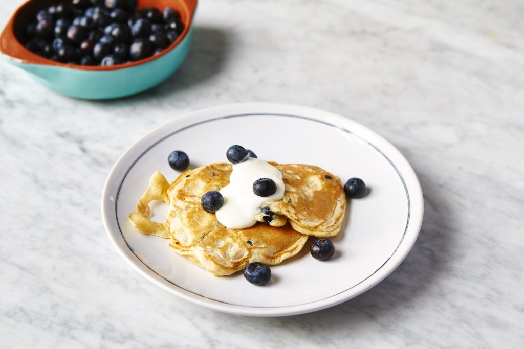 pancakes with blueberries and cream on top