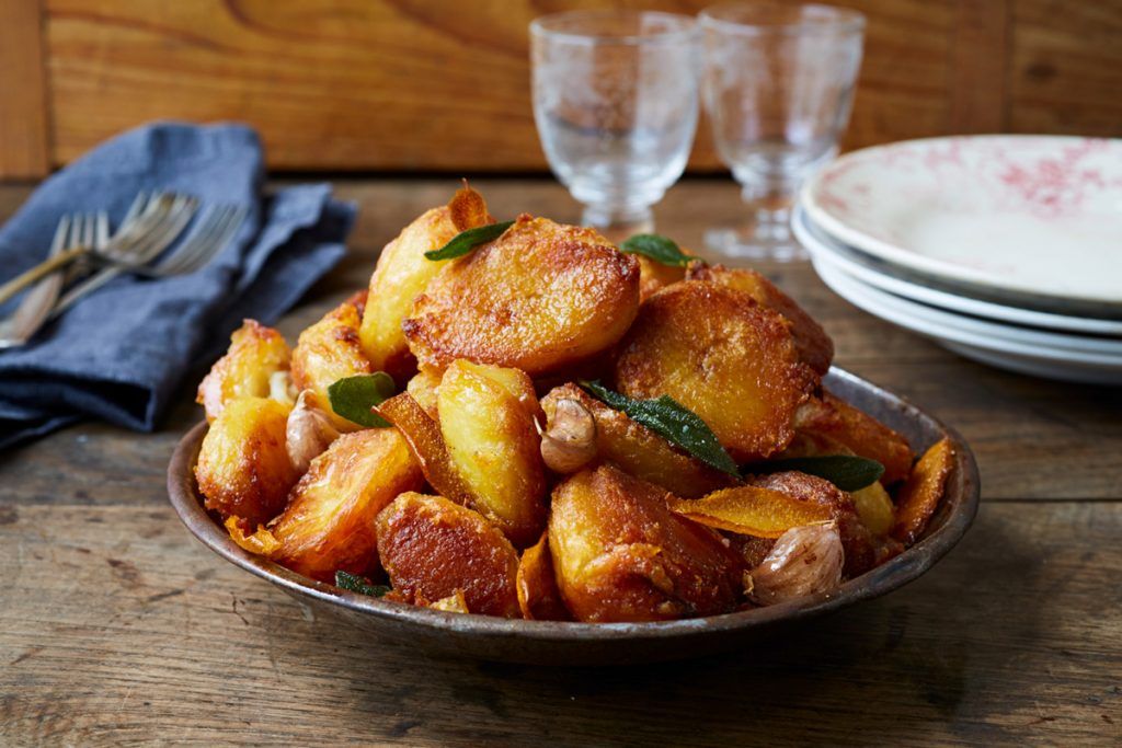 a plate filled with roast potatoes - spuds