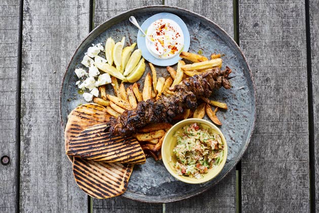 lamb kebabs with chips, pitta bread, sour cream and guacamole