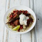 chilli meatballs with rice and yoghurt and herbs on top