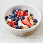 bowl of healthy breakfast oats with berries and yoghurt on top