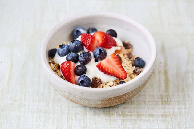 bowl of healthy breakfast oats with berries and yoghurt on top