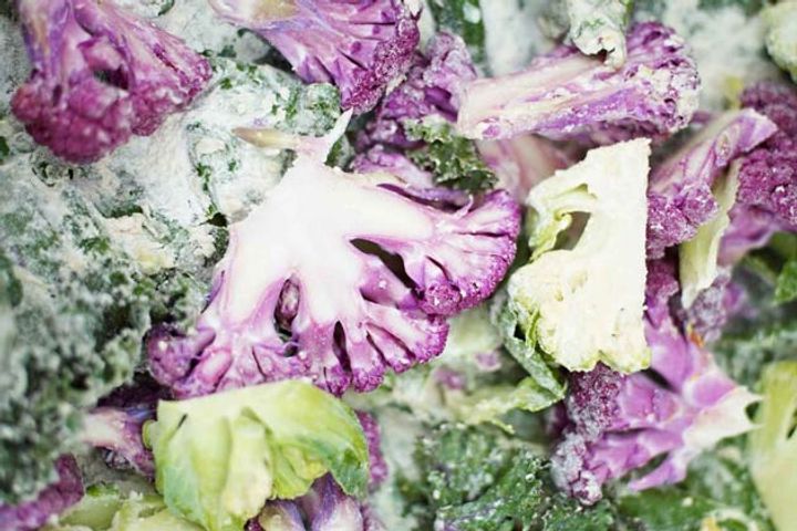 Sliced purple and green broccoli flourettes