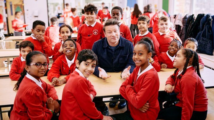 Jamie with kids at a school for Good School Food Awards