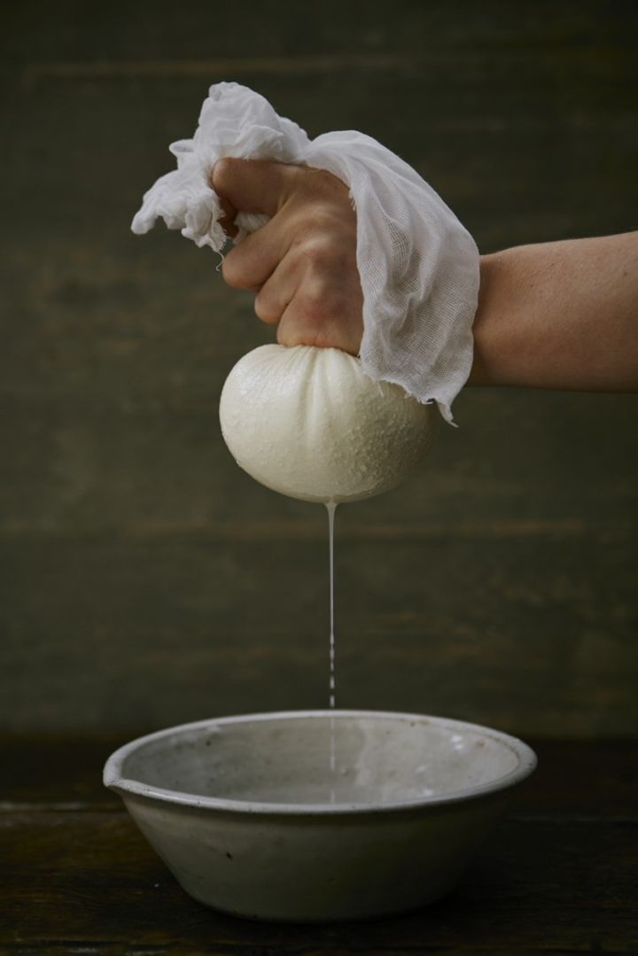 Image of liquid being squeezed out of paneer into a bowl