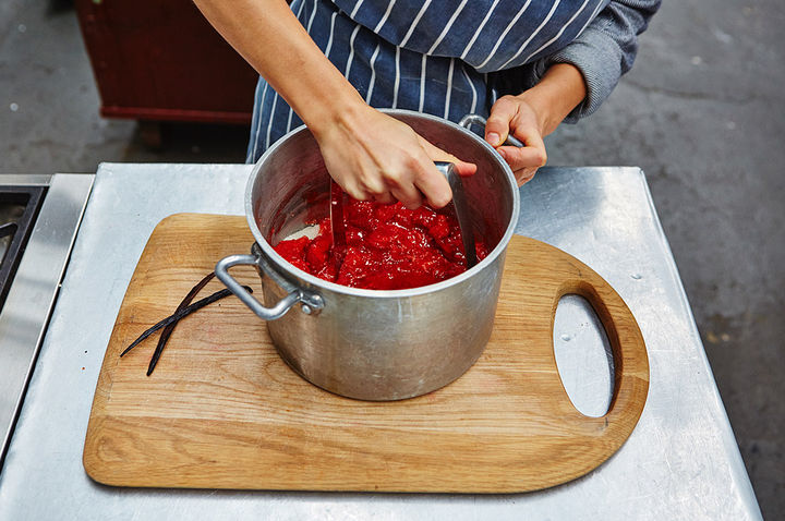 Image of fruit and sugar being mashed to make jam