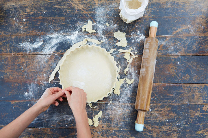 Image of pastry base being fit into pastry tin