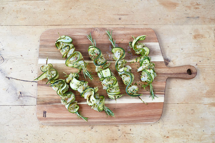 Image of kebabs on skewers with strips of courgette woven between the meat