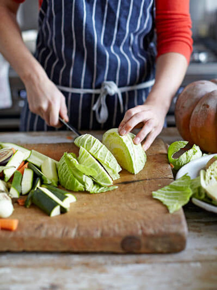 Image of cabbage being chopped into large chunks