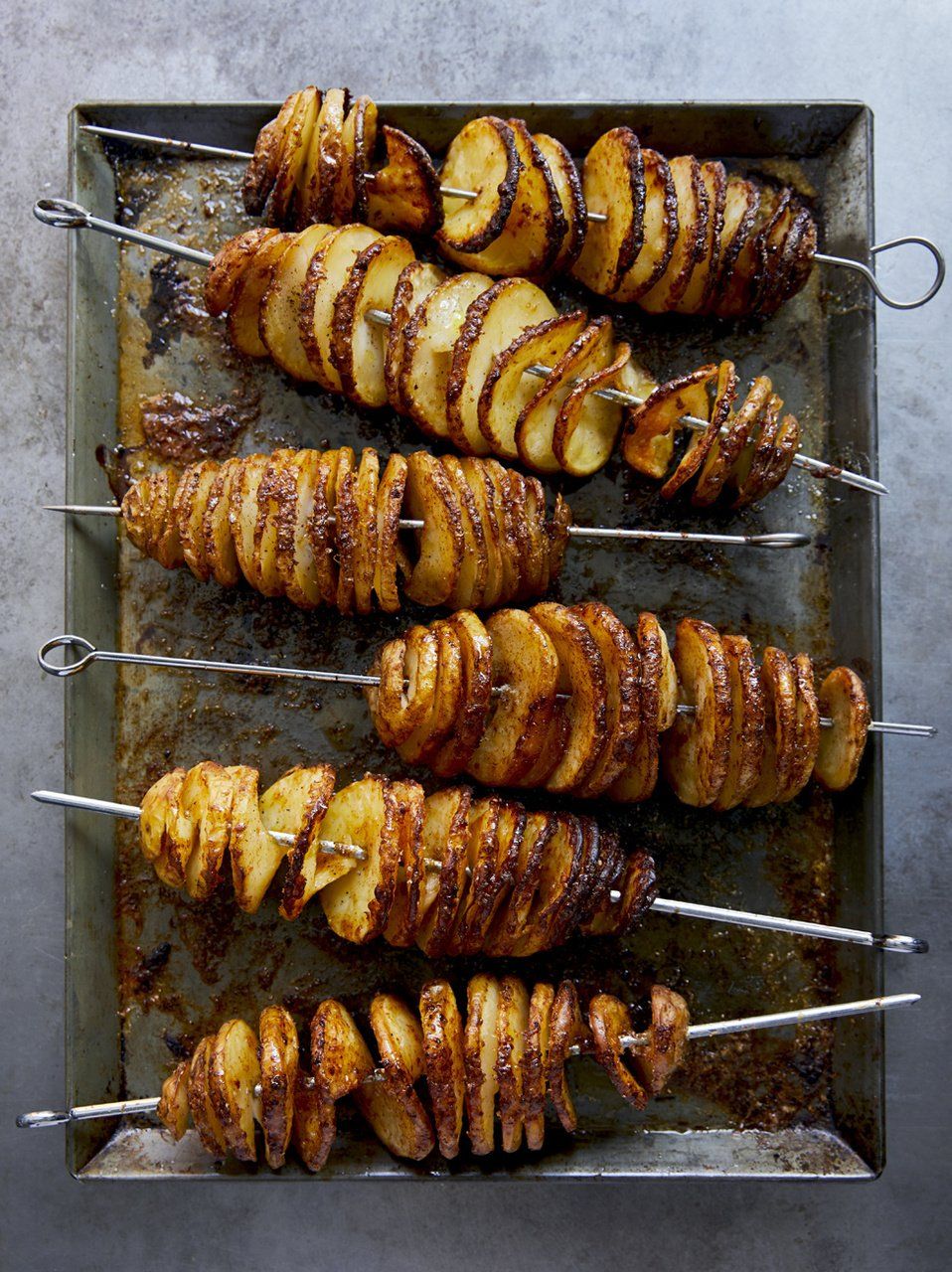 Spirals of roasted potatoes in a pan, from Jamie Oliver recipe