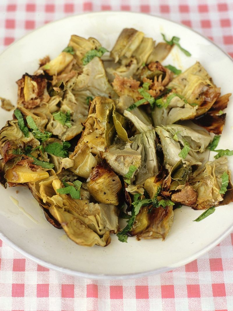Cinder-baked artichokes with lemon, bay and prosciutto