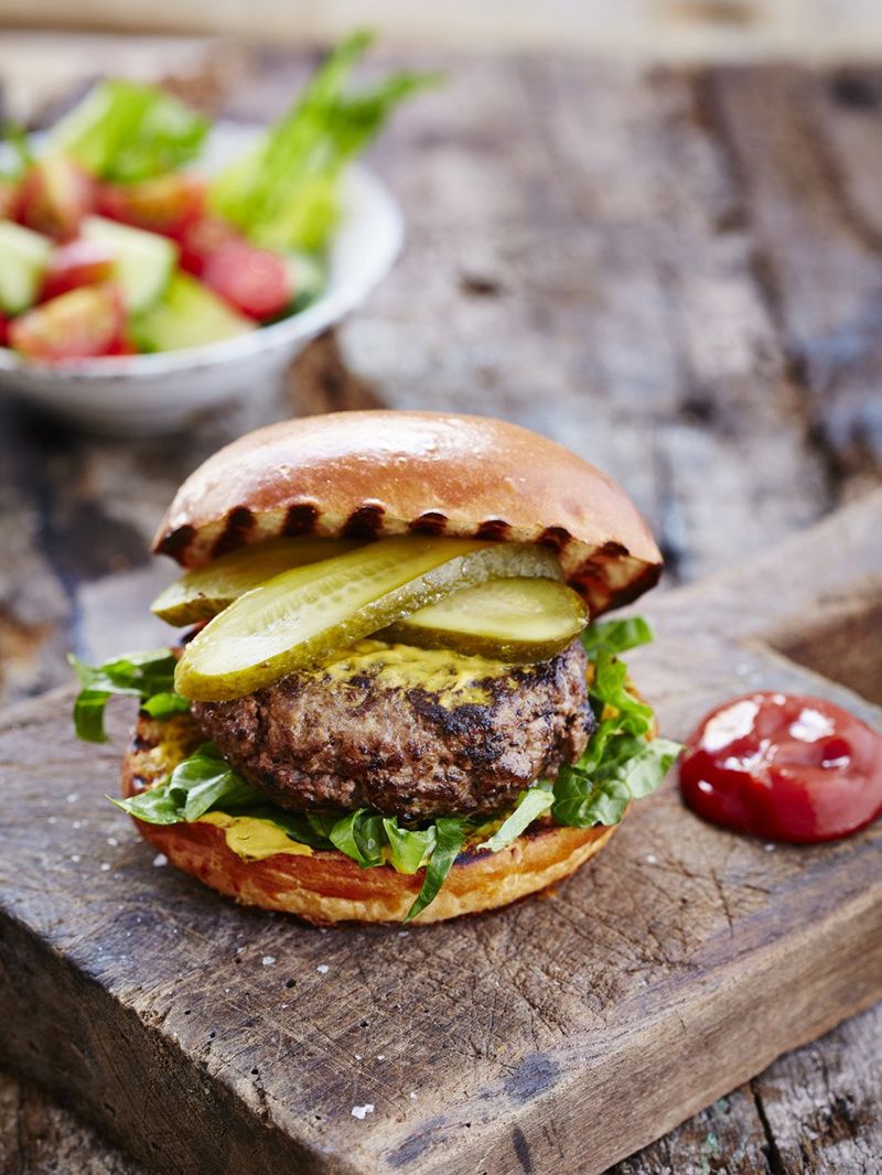 Elvis burger with chopped salad and pickled gherkin