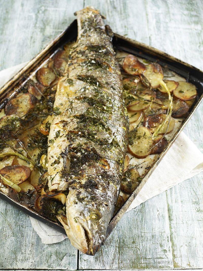 Whole roasted salmon stuffed with lemon and herbs